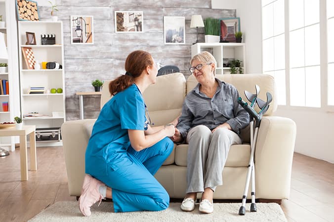 Allied health therapist supporting a stroke survivor